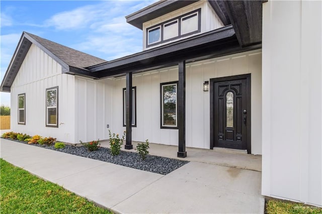 view of exterior entry featuring a porch