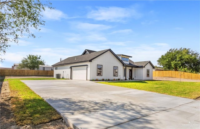 view of front of property with a garage and a front lawn