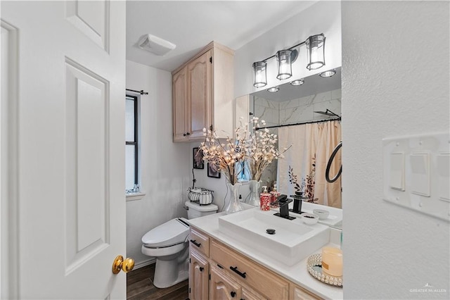 bathroom featuring hardwood / wood-style floors, vanity, a shower with shower curtain, and toilet