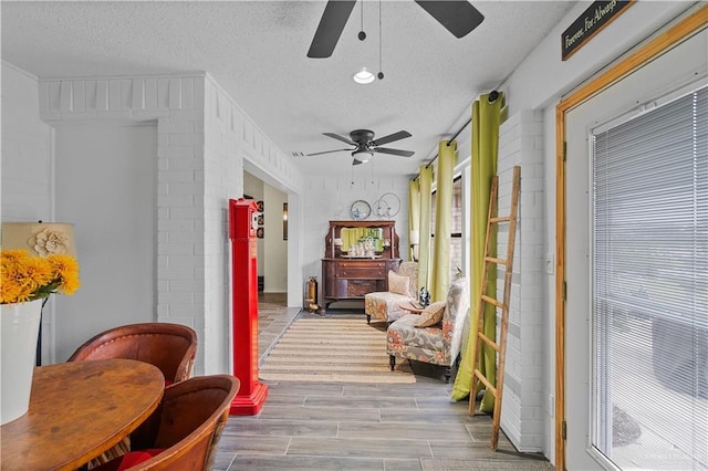 corridor featuring a textured ceiling and light hardwood / wood-style floors