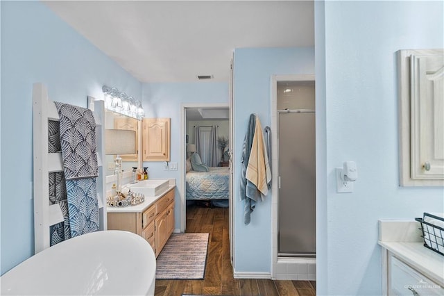 bathroom featuring vanity, hardwood / wood-style flooring, and separate shower and tub