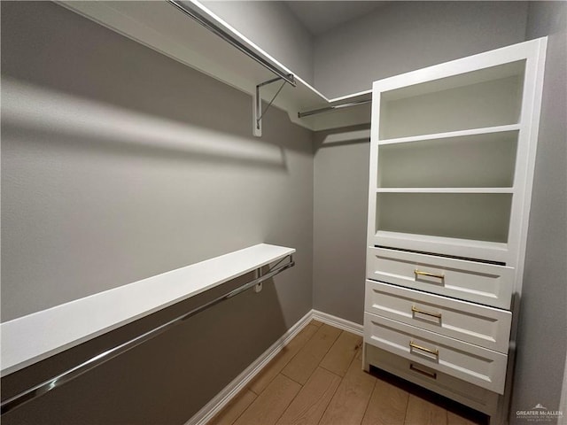 walk in closet featuring light wood finished floors