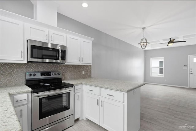 kitchen with white cabinetry, tasteful backsplash, stainless steel appliances, and kitchen peninsula