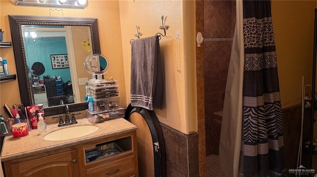 bathroom featuring walk in shower and vanity