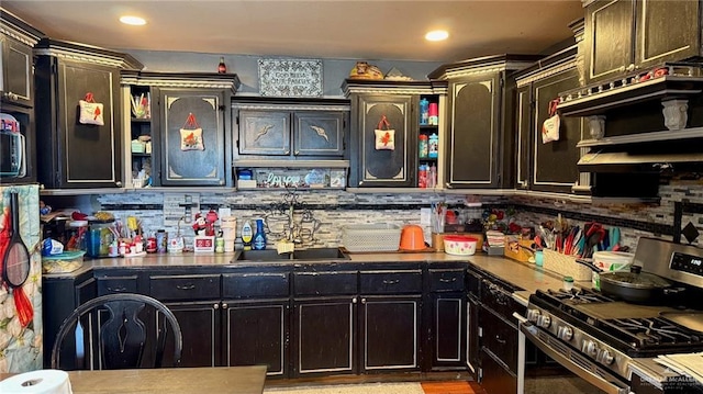 kitchen with sink, gas stove, and decorative backsplash