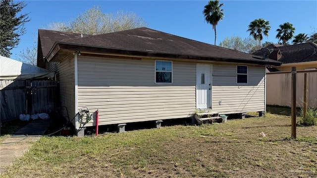 rear view of property with a yard