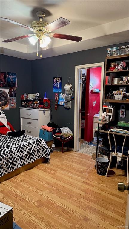 bedroom with ceiling fan, a closet, and hardwood / wood-style flooring