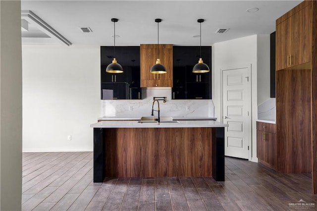 kitchen with pendant lighting, backsplash, and sink