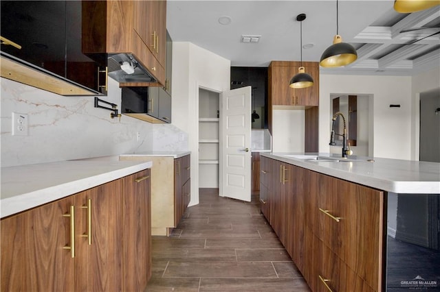 kitchen with coffered ceiling, sink, hanging light fixtures, decorative backsplash, and beamed ceiling