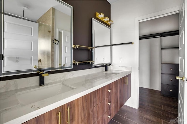 bathroom with vanity and a shower with shower door