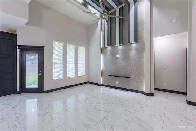 unfurnished living room with ceiling fan