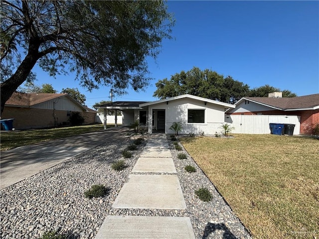 ranch-style home with a front yard and a carport