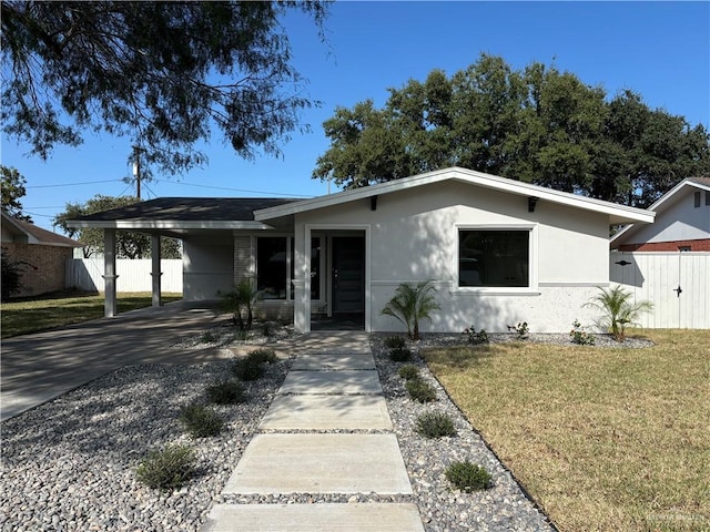 ranch-style house with a front lawn and a carport