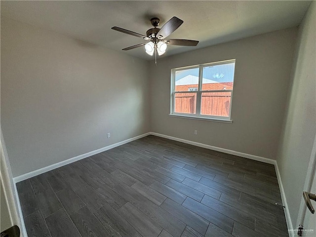 spare room with ceiling fan and dark hardwood / wood-style flooring