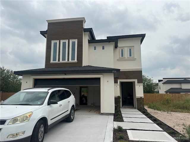 2710 Melody St, Mission, TX 78574 - view of front of house featuring an attached garage, concrete driveway, and stucco siding
