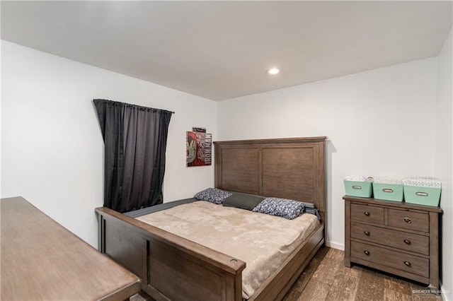 bedroom with dark wood-type flooring, recessed lighting, and baseboards