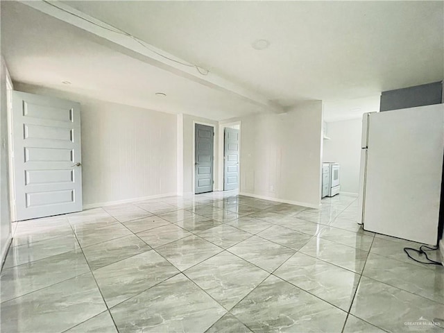 unfurnished room featuring beam ceiling and baseboards