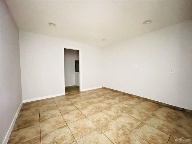 spare room with light tile patterned floors, baseboards, and recessed lighting