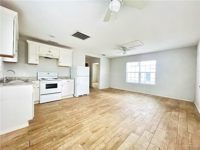 kitchen with light countertops, visible vents, a sink, white appliances, and under cabinet range hood