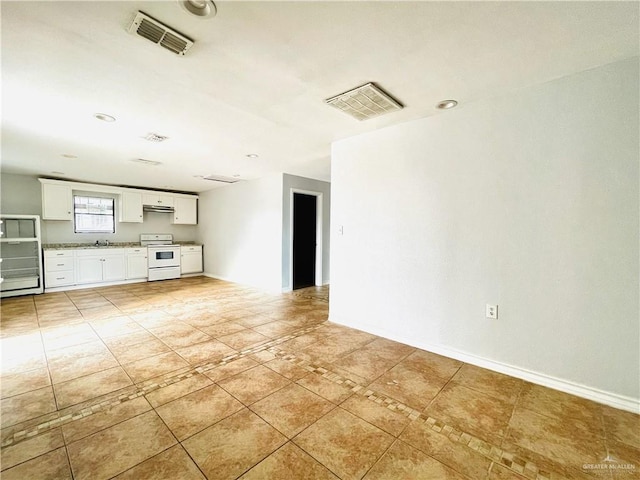 unfurnished living room with visible vents, baseboards, and light tile patterned floors