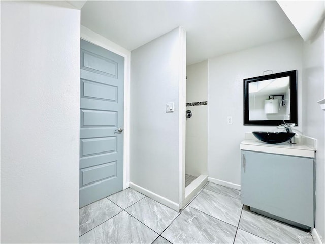 bathroom with a stall shower, baseboards, marble finish floor, and vanity