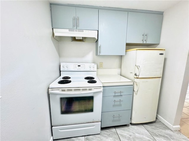 kitchen with white appliances, under cabinet range hood, light countertops, and gray cabinetry