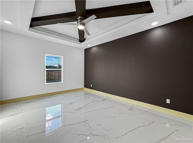 unfurnished room with a raised ceiling and ceiling fan