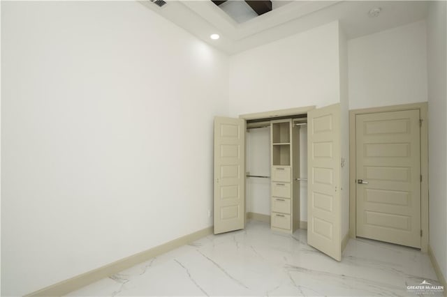 2613 Linva Ave, Edinburg, TX 78539 - unfurnished bedroom with light marble finish floors, recessed lighting, a closet, and a towering ceiling
