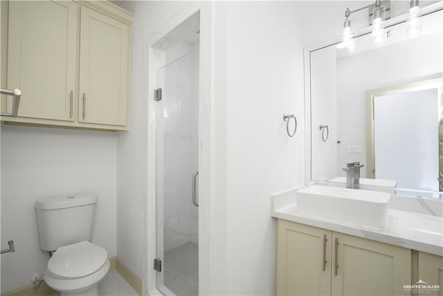 bathroom featuring an enclosed shower, vanity, and toilet