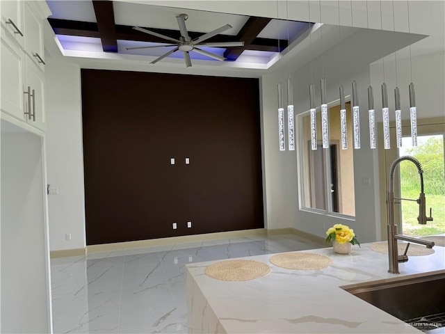 interior space featuring beam ceiling, coffered ceiling, and sink