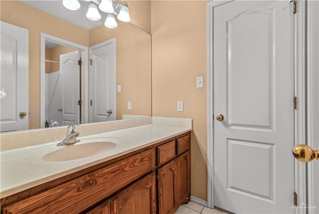 bathroom featuring a notable chandelier, vanity, and tile patterned floors