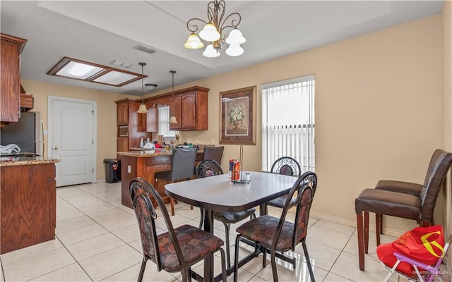 dining area with an inviting chandelier and light tile patterned flooring