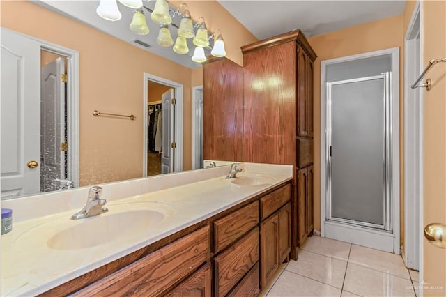 bathroom featuring a chandelier, vanity, tile patterned floors, and an enclosed shower