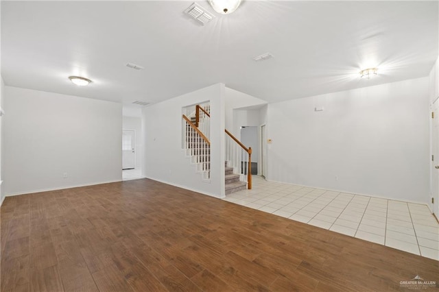 2504 Grayson Ave, Mcallen, TX 78504 - unfurnished living room with stairway and wood finished floors
