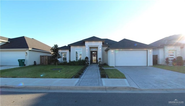 view of front of property featuring a garage and a front lawn