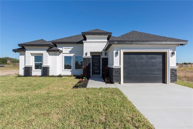 prairie-style home featuring a garage, a front lawn, and cooling unit