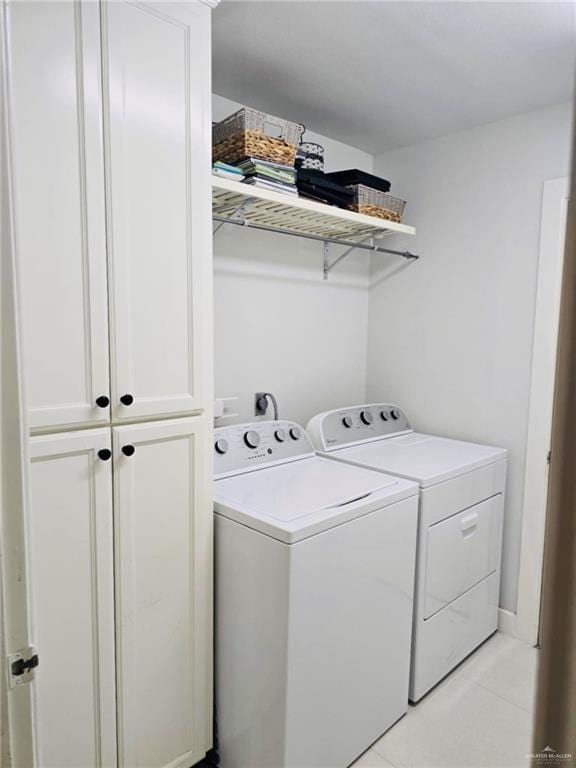 laundry room with cabinets and separate washer and dryer