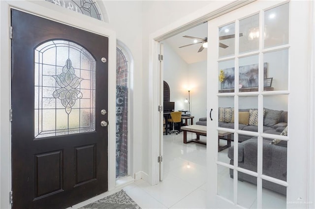 tiled entryway featuring ceiling fan