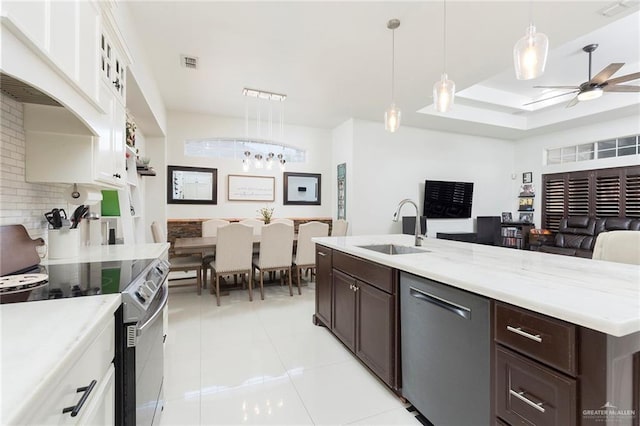 kitchen with white cabinetry, sink, hanging light fixtures, and appliances with stainless steel finishes