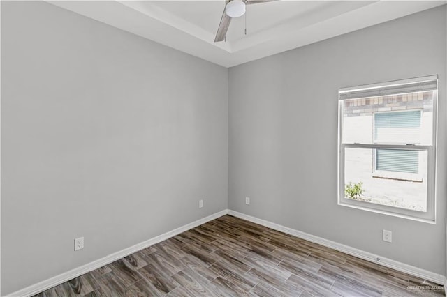 spare room featuring wood-type flooring and ceiling fan