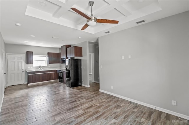 kitchen featuring coffered ceiling, ceiling fan, sink, black appliances, and light hardwood / wood-style flooring