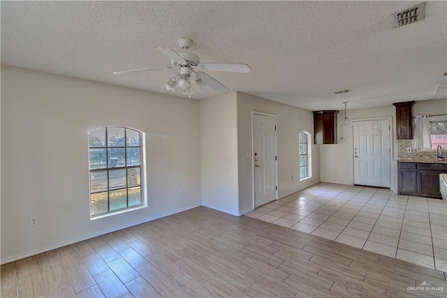 2800 Del Oro Dr, Mission, TX 78572 - unfurnished room with light wood-type flooring, a textured ceiling, ceiling fan, and visible vents