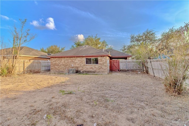 2800 Del Oro Dr, Mission, TX 78572 - back of property featuring a fenced backyard, brick siding, and central AC