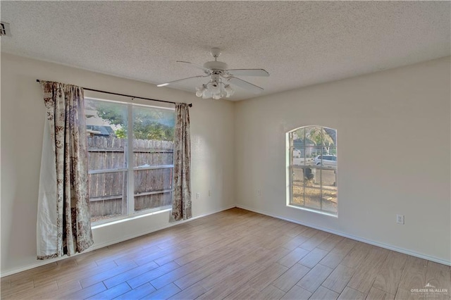 2800 Del Oro Dr, Mission, TX 78572 - unfurnished room featuring a ceiling fan, a textured ceiling, baseboards, and wood finished floors
