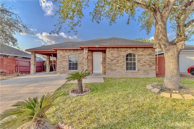 2800 Del Oro Dr, Mission, TX 78572 - ranch-style home featuring concrete driveway, fence, a front yard, brick siding, and an attached carport