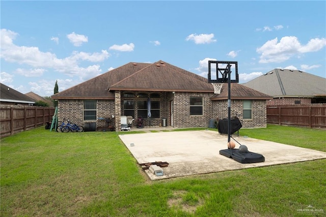 back of property with a lawn and a patio area