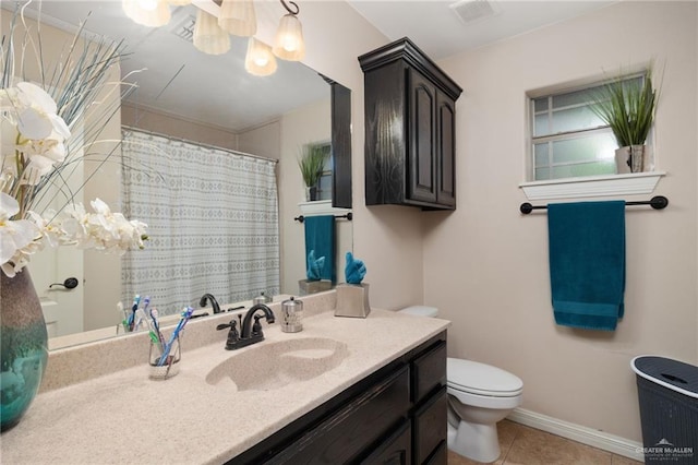 bathroom with tile patterned flooring, vanity, and toilet