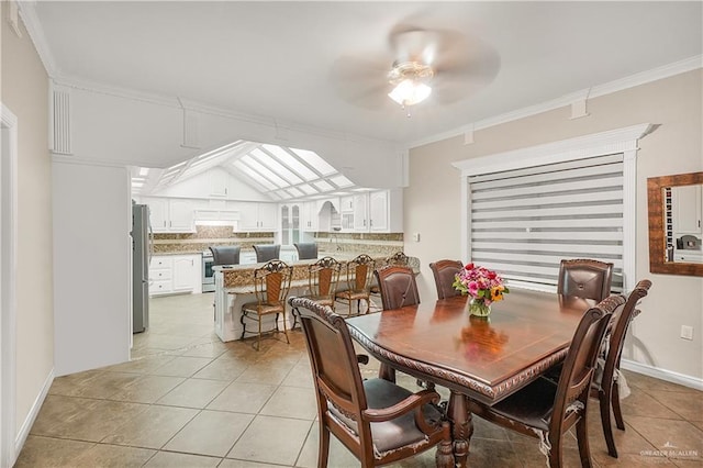 5051 Iowa Rd, Mission, TX 78574 - dining area featuring light tile patterned flooring, ceiling fan, and crown molding