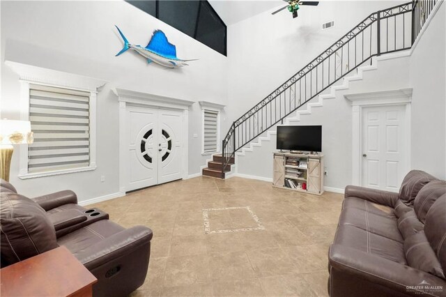 5051 Iowa Rd, Mission, TX 78574 - tiled living area featuring stairway, baseboards, a towering ceiling, and a ceiling fan