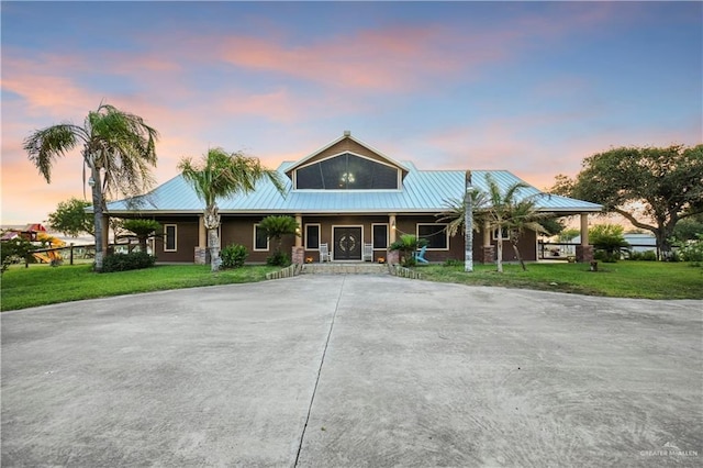 5051 Iowa Rd, Mission, TX 78574 - country-style home featuring covered porch, a front yard, metal roof, and driveway